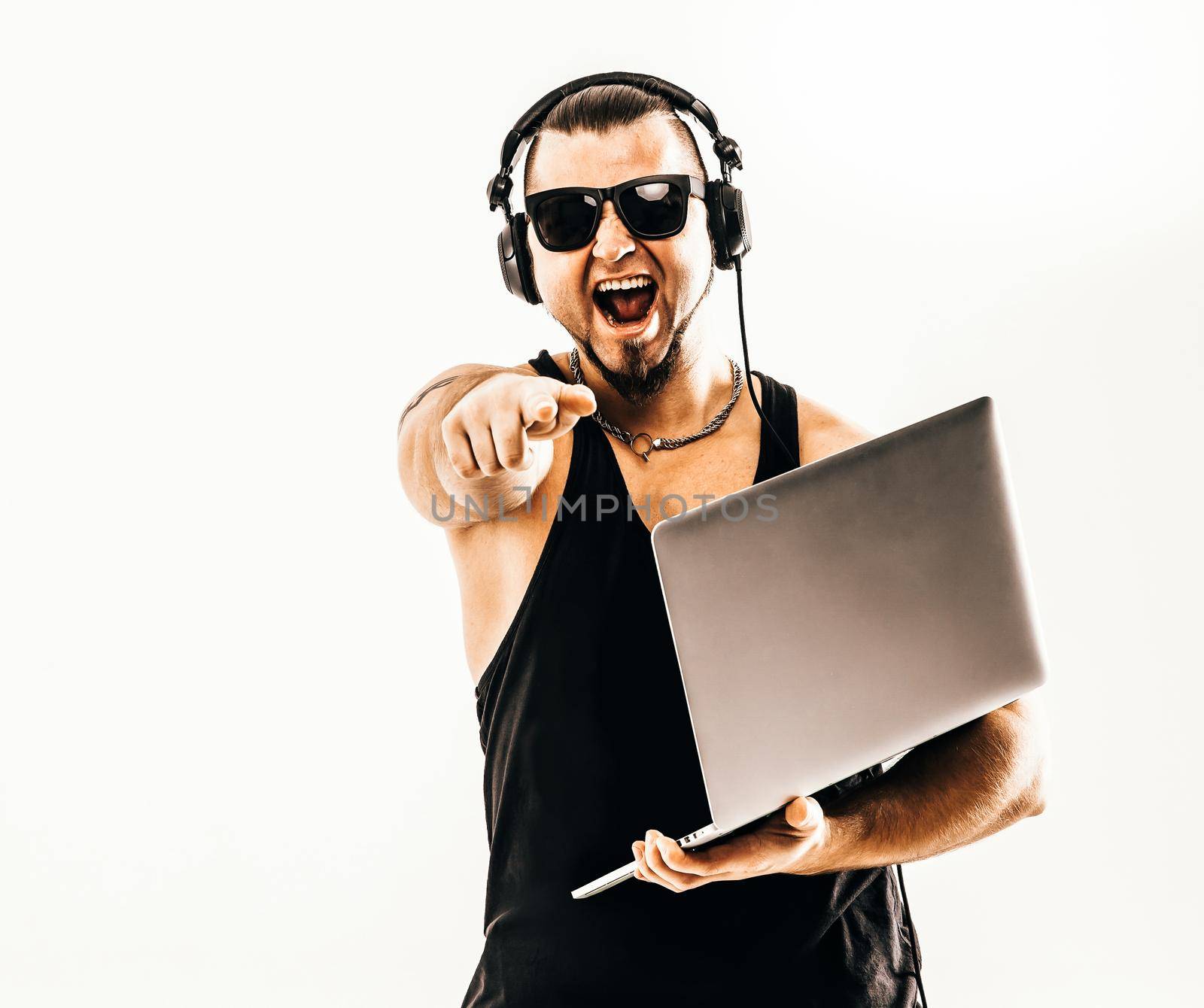 charismatic DJ - rapper in headphones and with a laptop .photo on a white background and has an empty space for your text