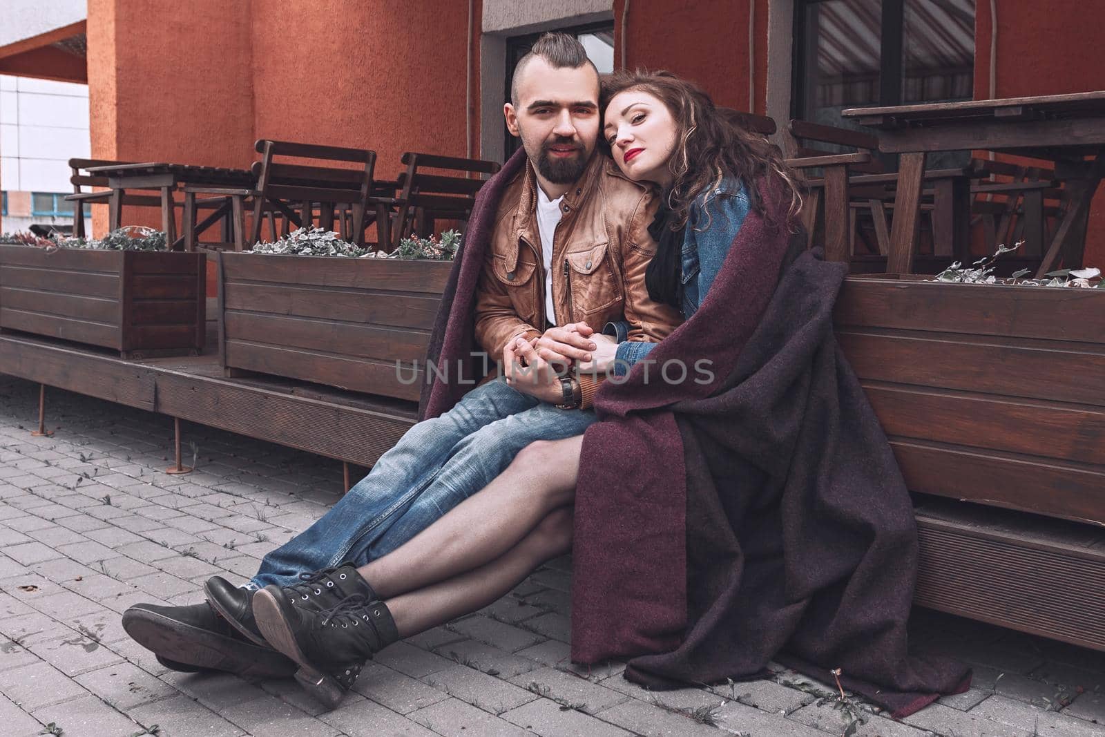 loving couple sitting on a bench, holding each other's hands . love story