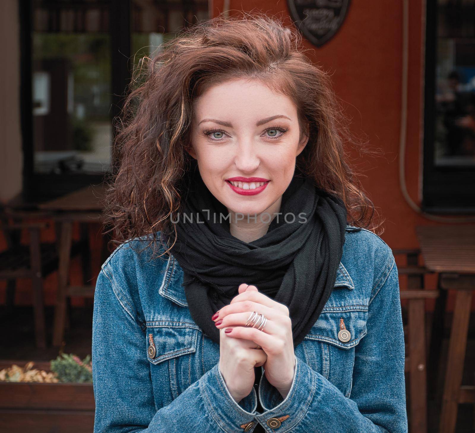 portrait of a modern young woman on the background of a street cafe
