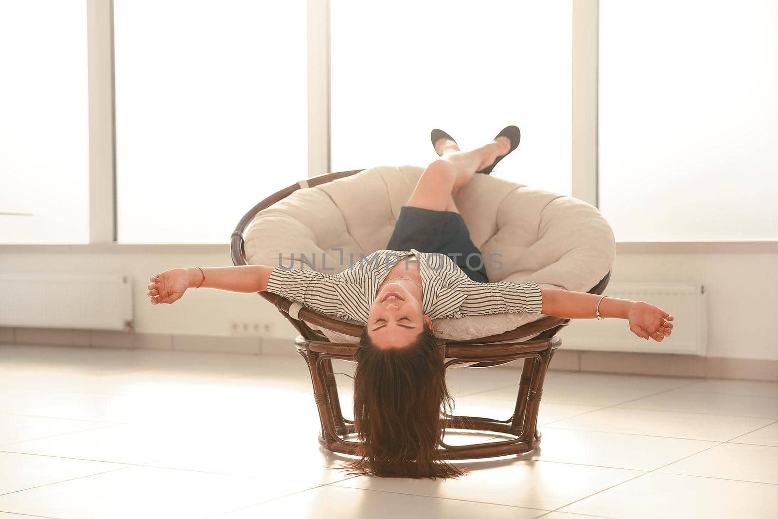 happy businesswoman relaxing in a comfortable chair by SmartPhotoLab