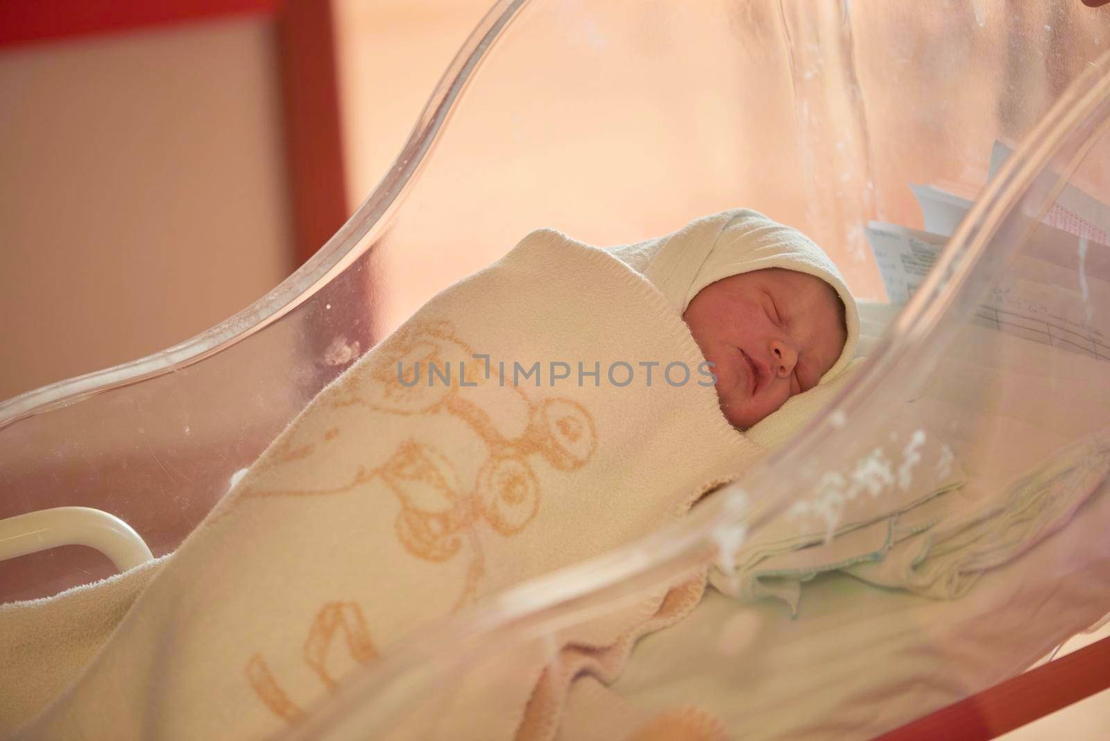 newborn baby sleeping in  bed at hospital by dotshock