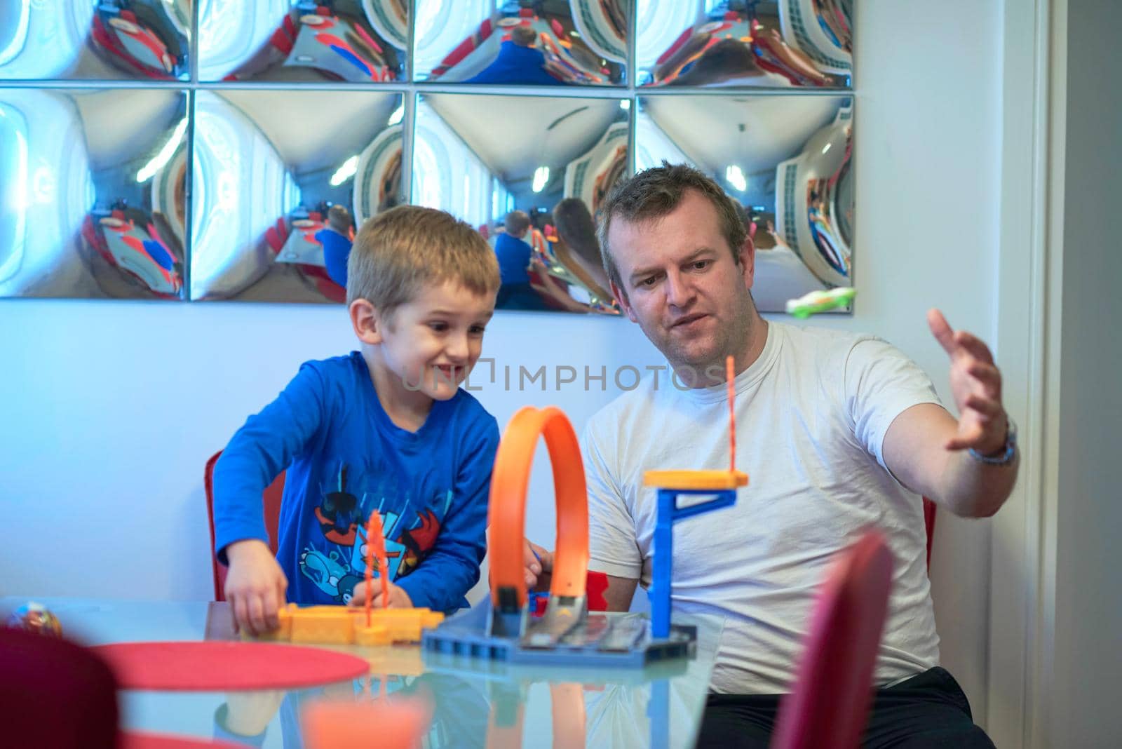 Father and children playing car toy game by dotshock