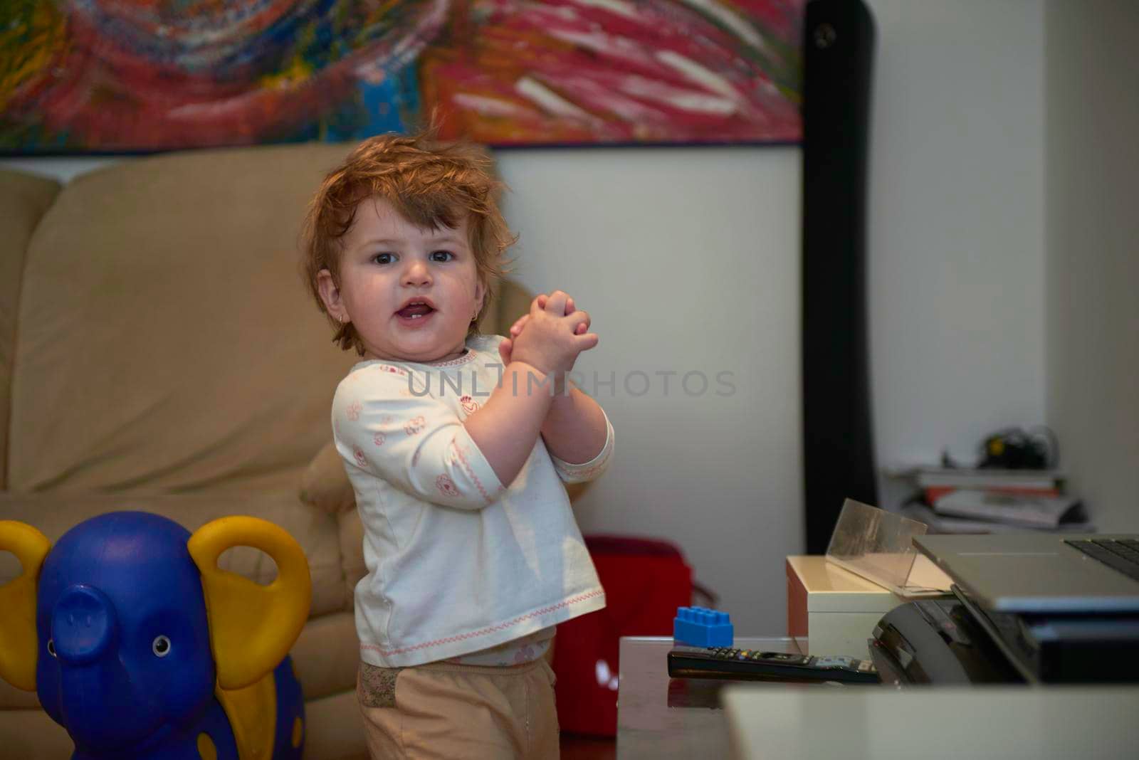 Adorable cute beautiful little baby girl playing with toys at home by dotshock