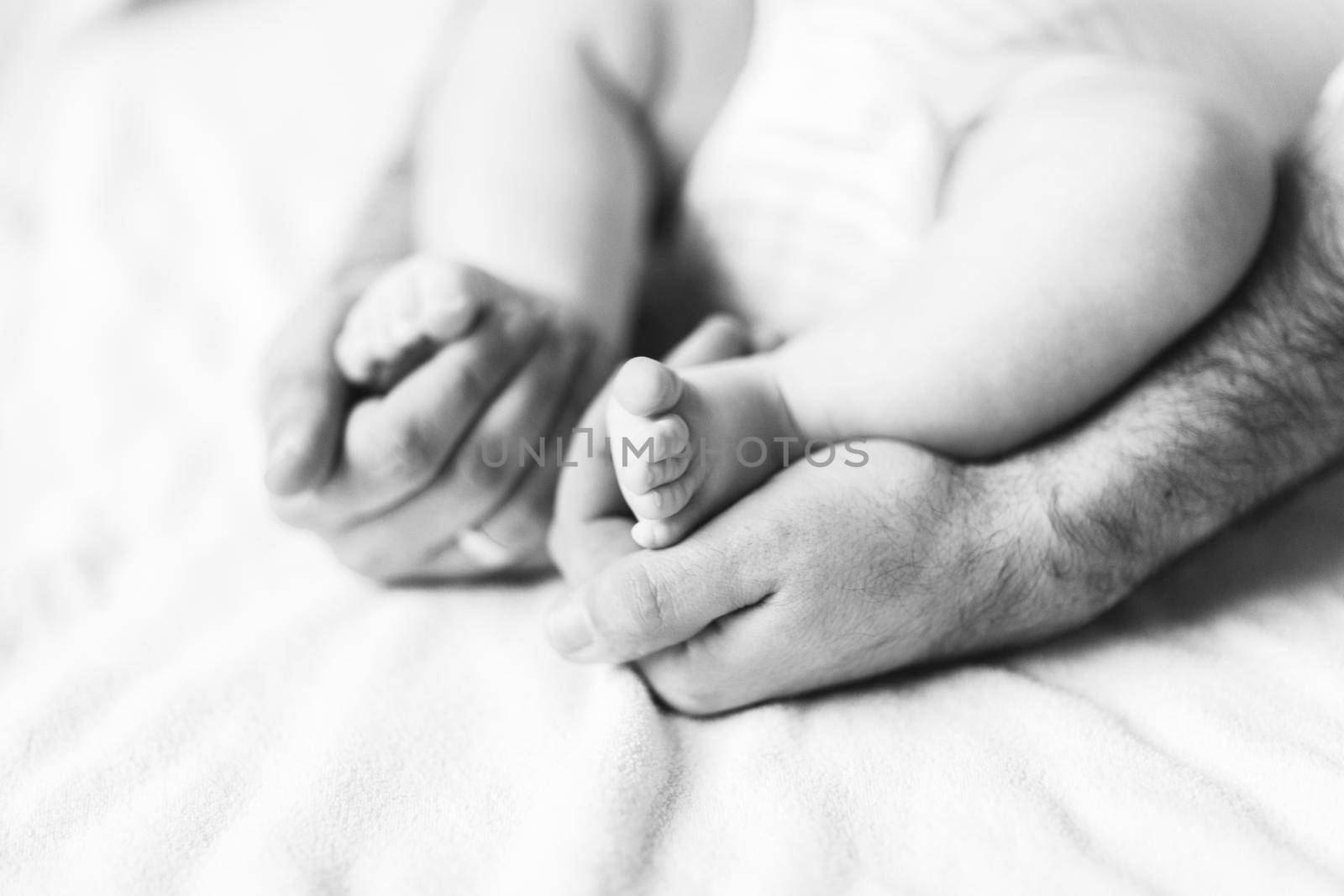 Children's feet in the hands of his father.conceptual image of fatherhood.photo with copy space