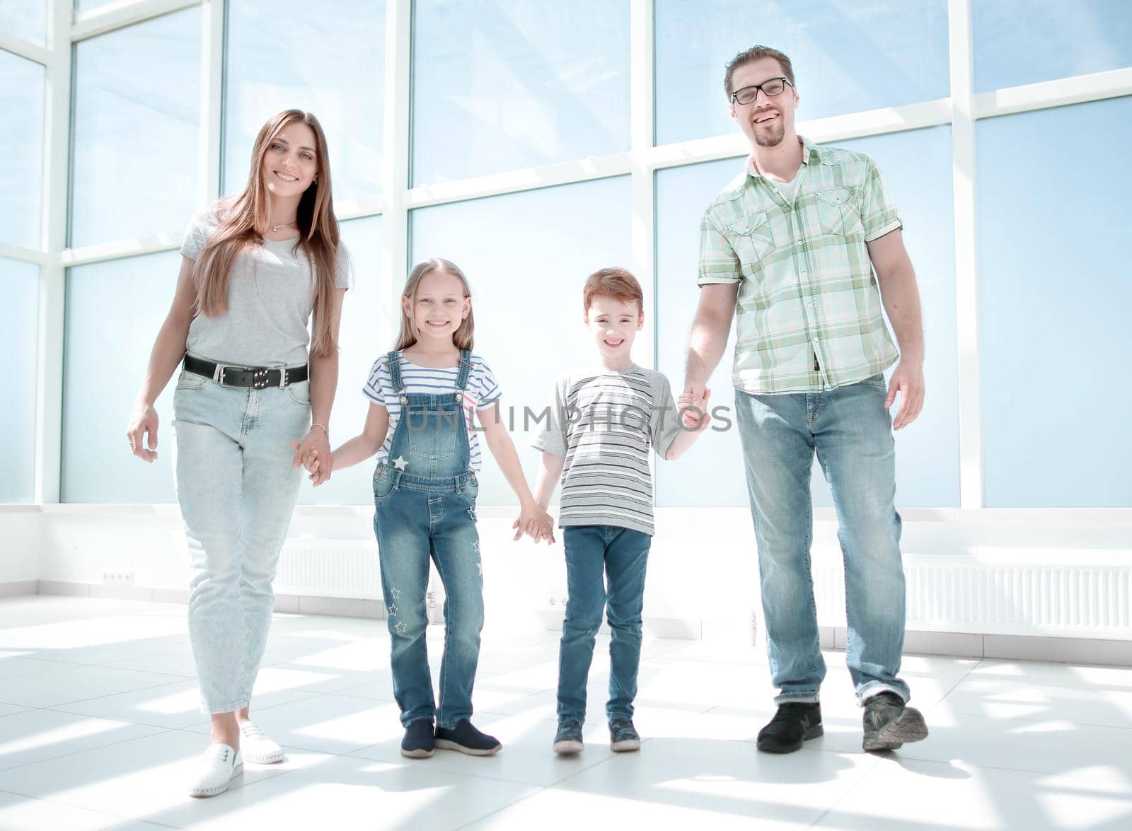 parents with small children standing in the new house .photo with copy space