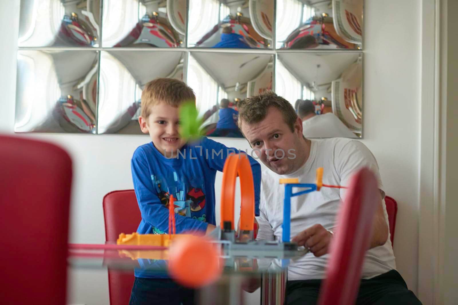 Father and children playing kids stunt racing toy car game