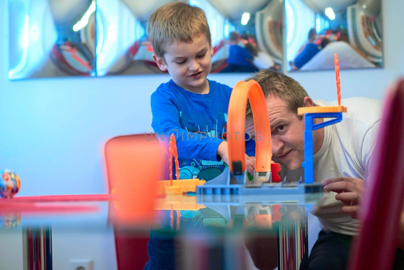 Father and children playing kids stunt racing toy car game