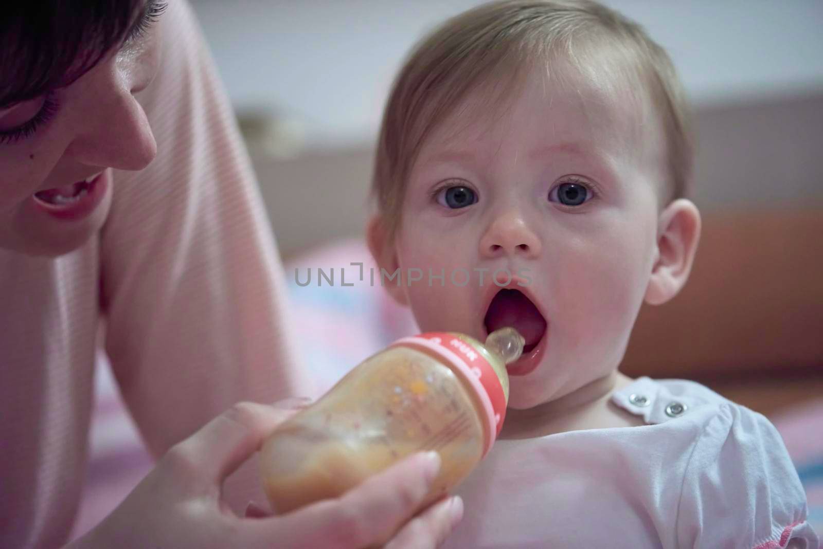 little baby  drinking juice  from bottle by dotshock