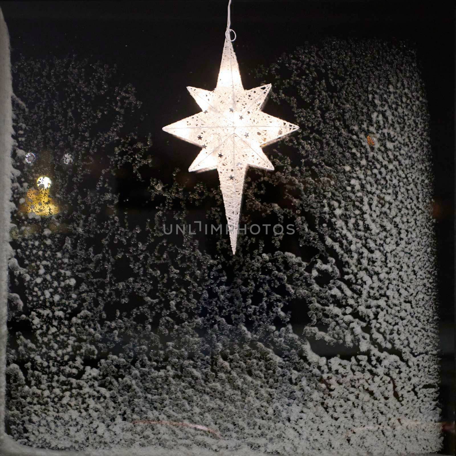Typical star for lightning in the window and decoration during the winter time for Christmas in Scandinavia. The star is meant to represent the Star of Bethlehem,  birth of JesusA Christmas star in the window. Warm light, Christmas, cosy atmosphere. Advent time.