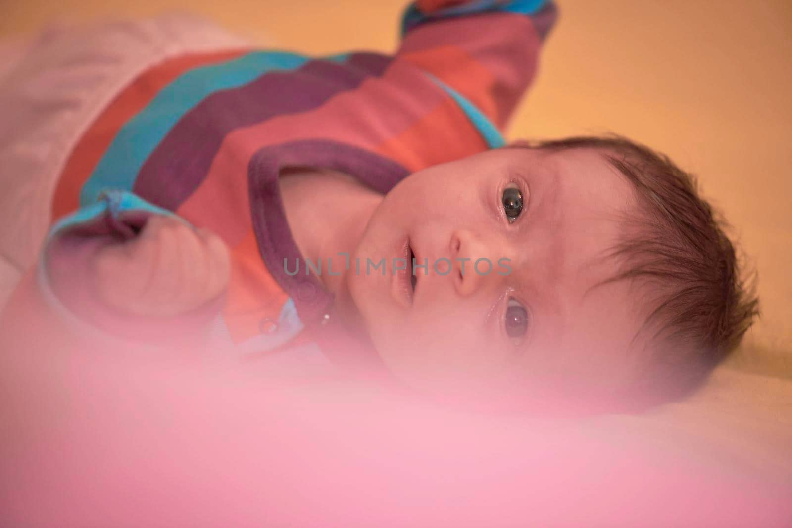 One month newborn baby in bed. Close up portrait of sleeping cute little girl