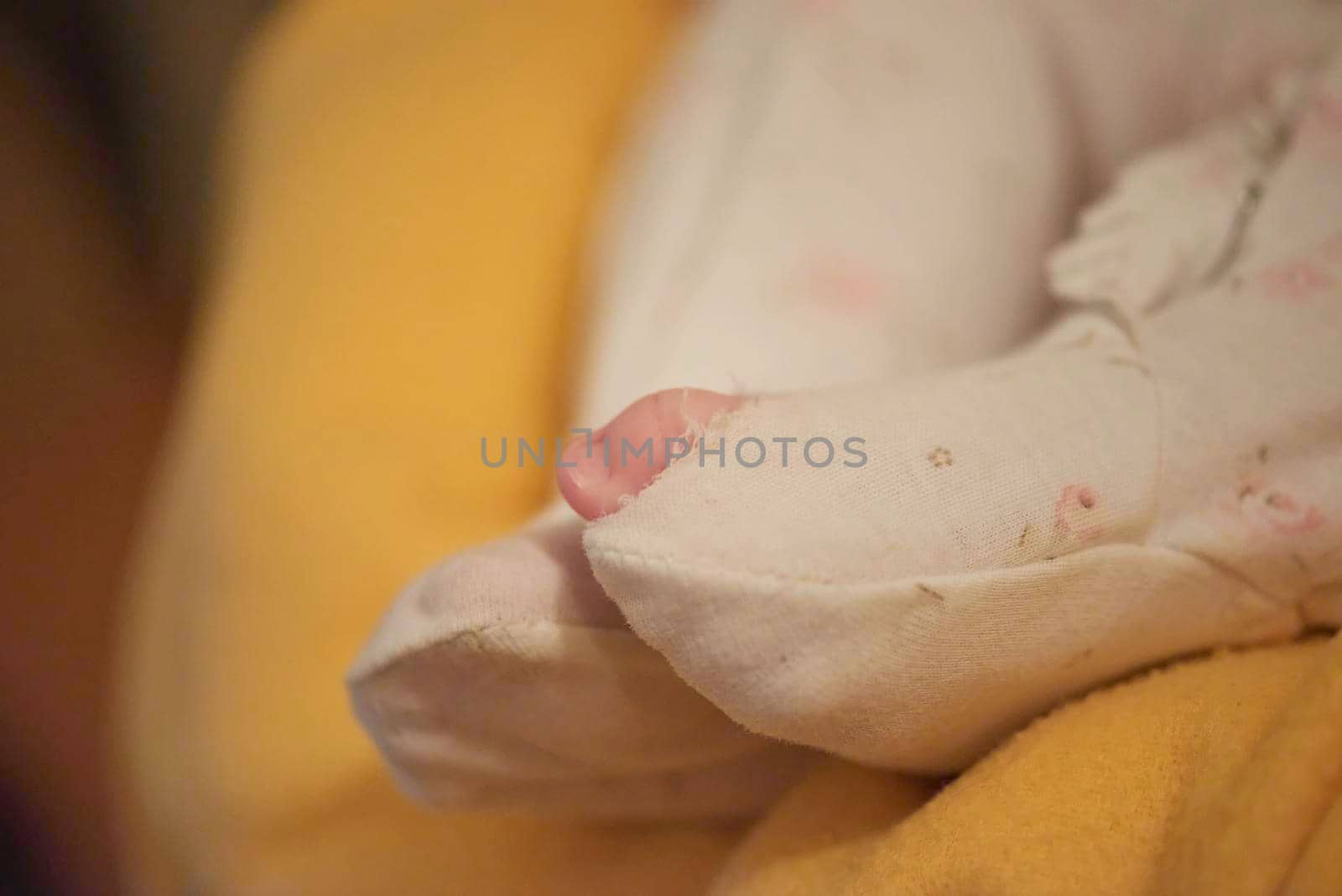 One month newborn baby in bed. Close up portrait of sleeping cute little girl