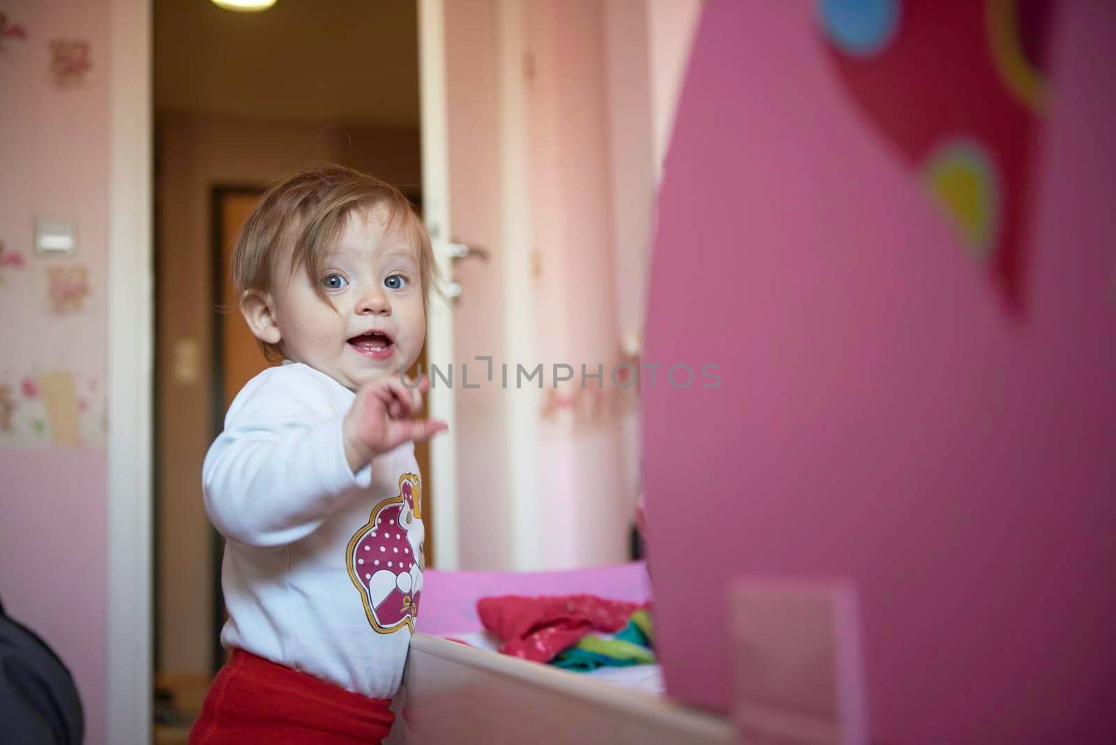 cute  little one year old baby and making first steps by dotshock