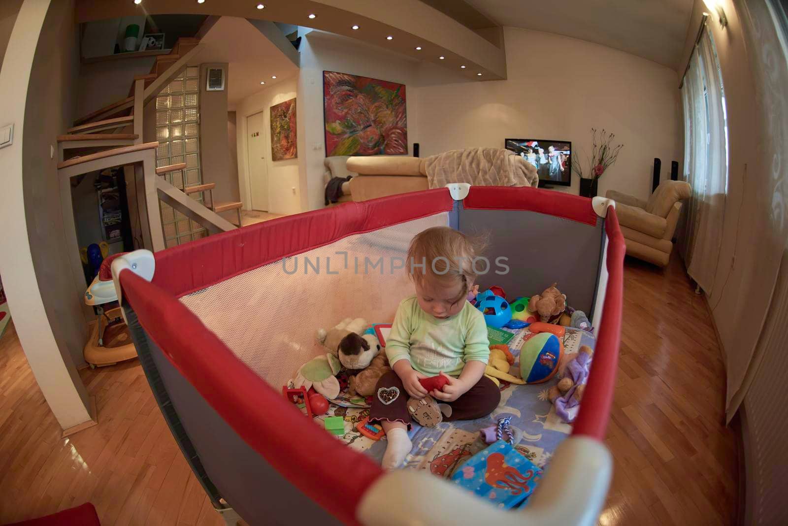 cute  little baby playing with toys in mobile bed making first steps and learnig to stand  and walk