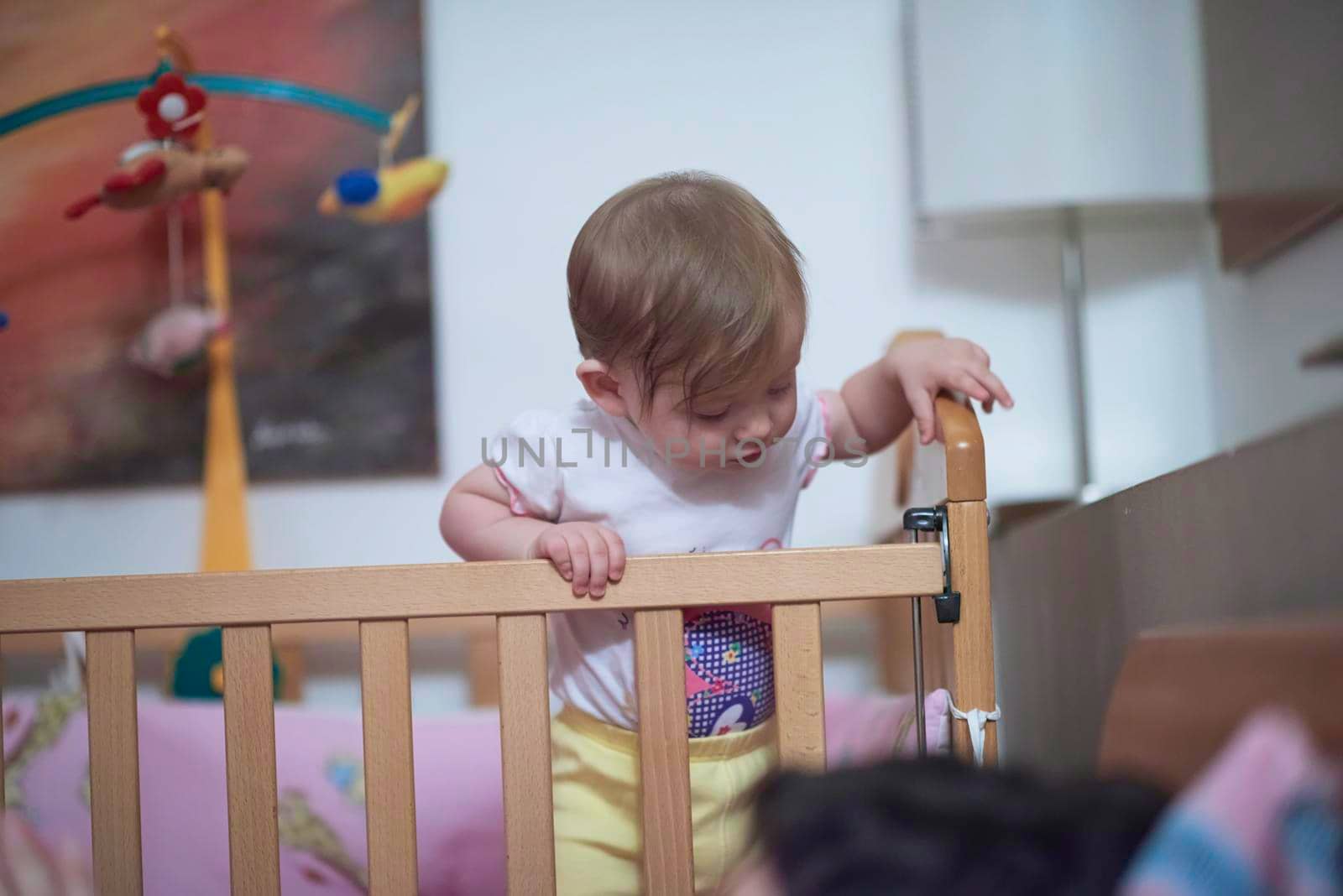 cute  little one year old baby and making first steps in bed by dotshock