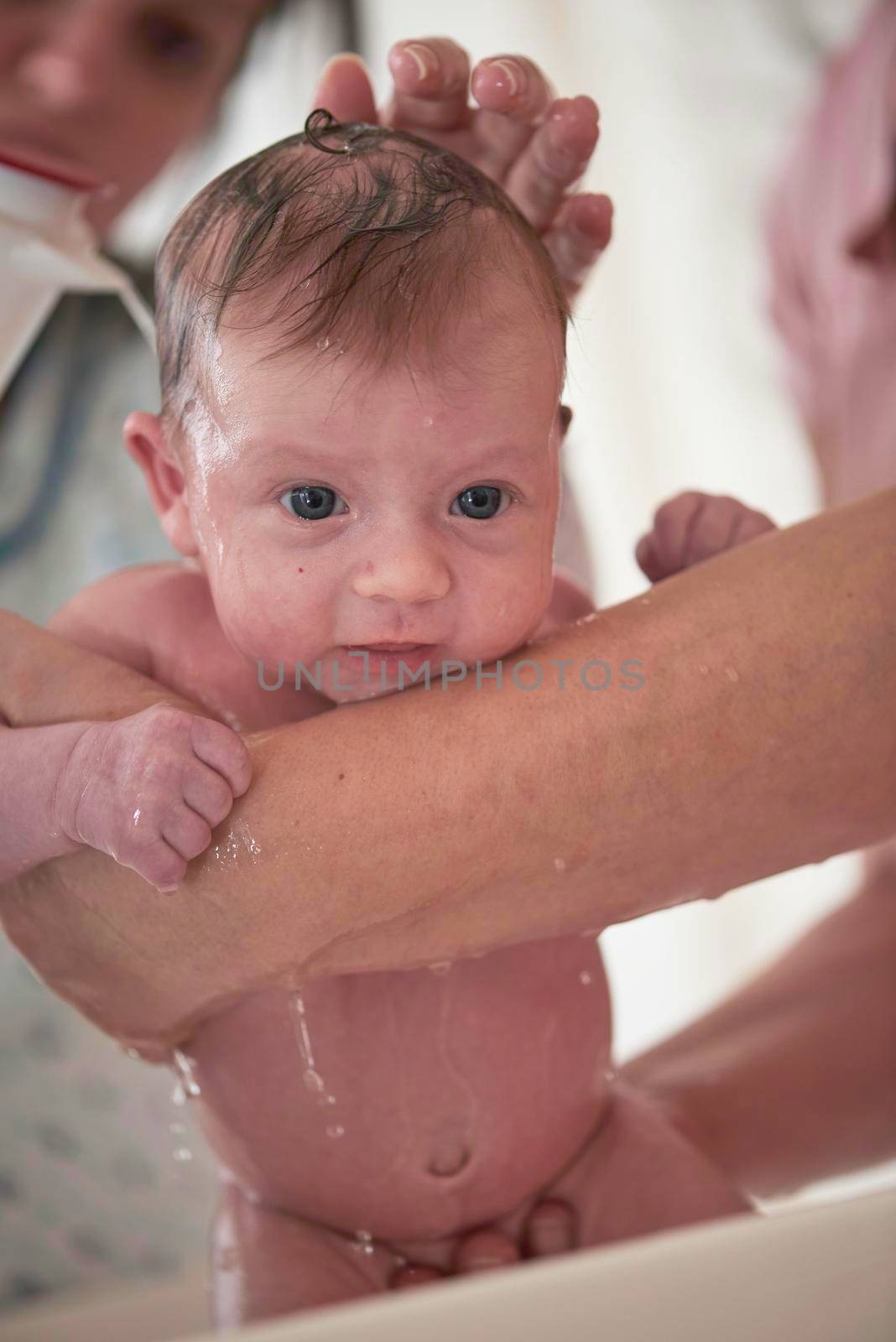 Mother is bathing Newborn baby girl taking a bath