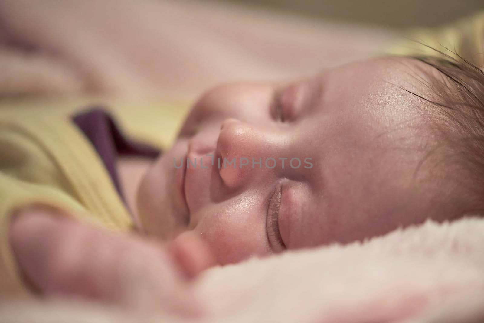newborn baby girl sleeping in bed at home