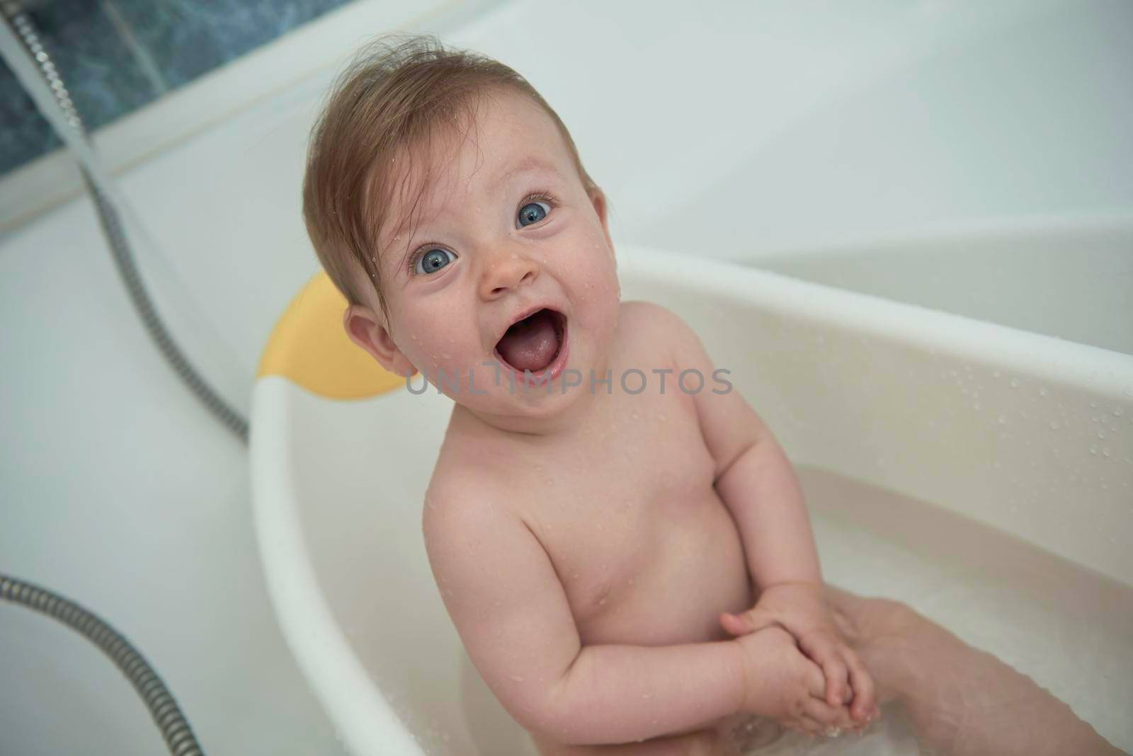 cute little baby girl taking a bath by dotshock