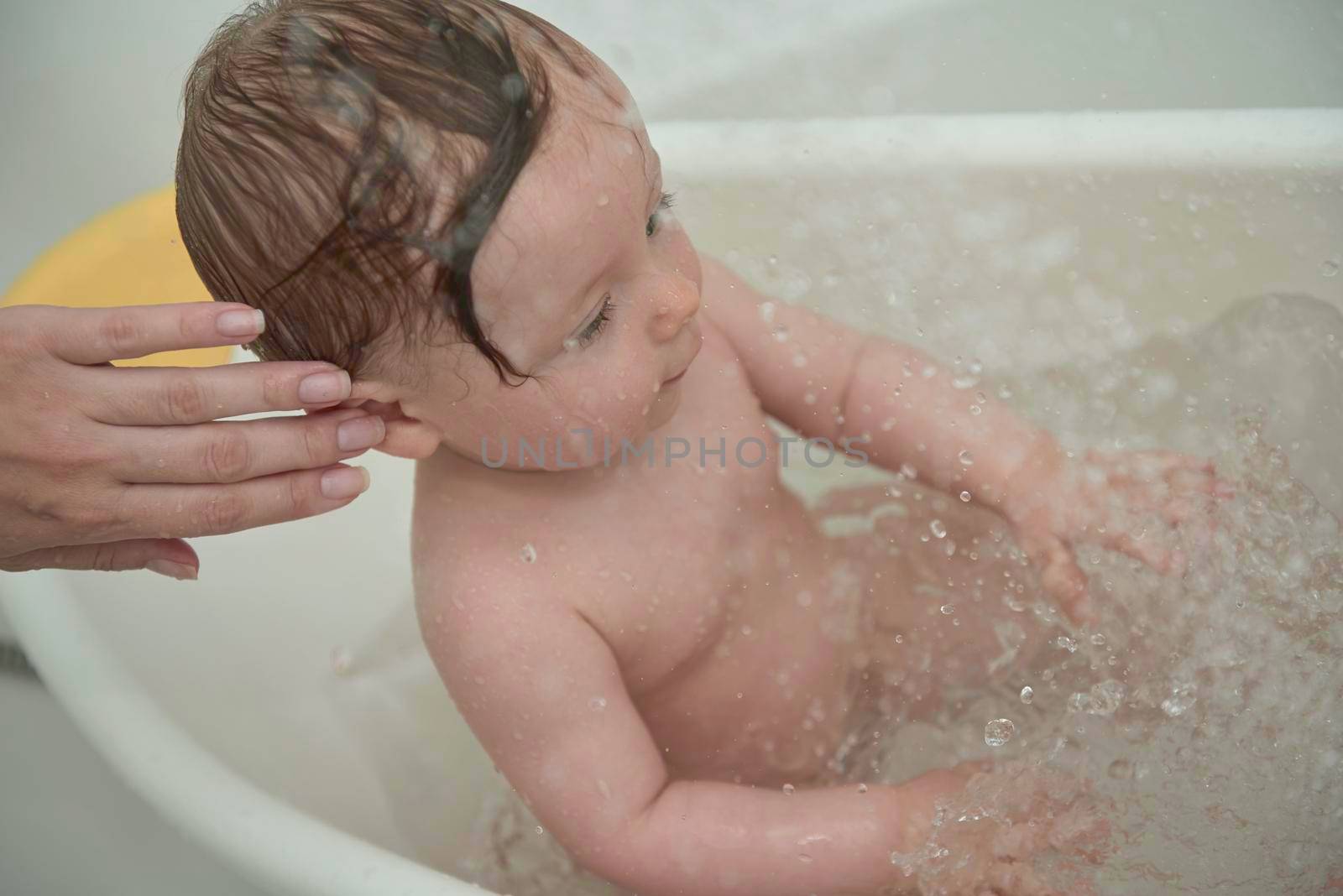 cute little baby girl taking a bath by dotshock
