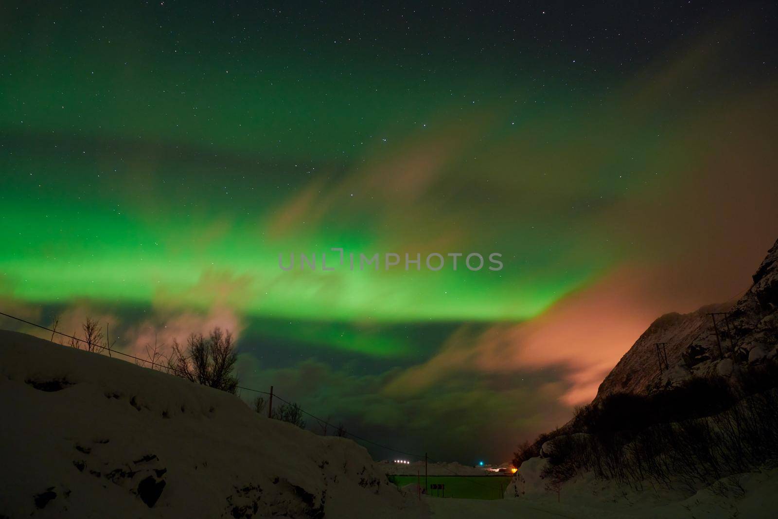 Aurora borealis Green northern lights above mountains by dotshock