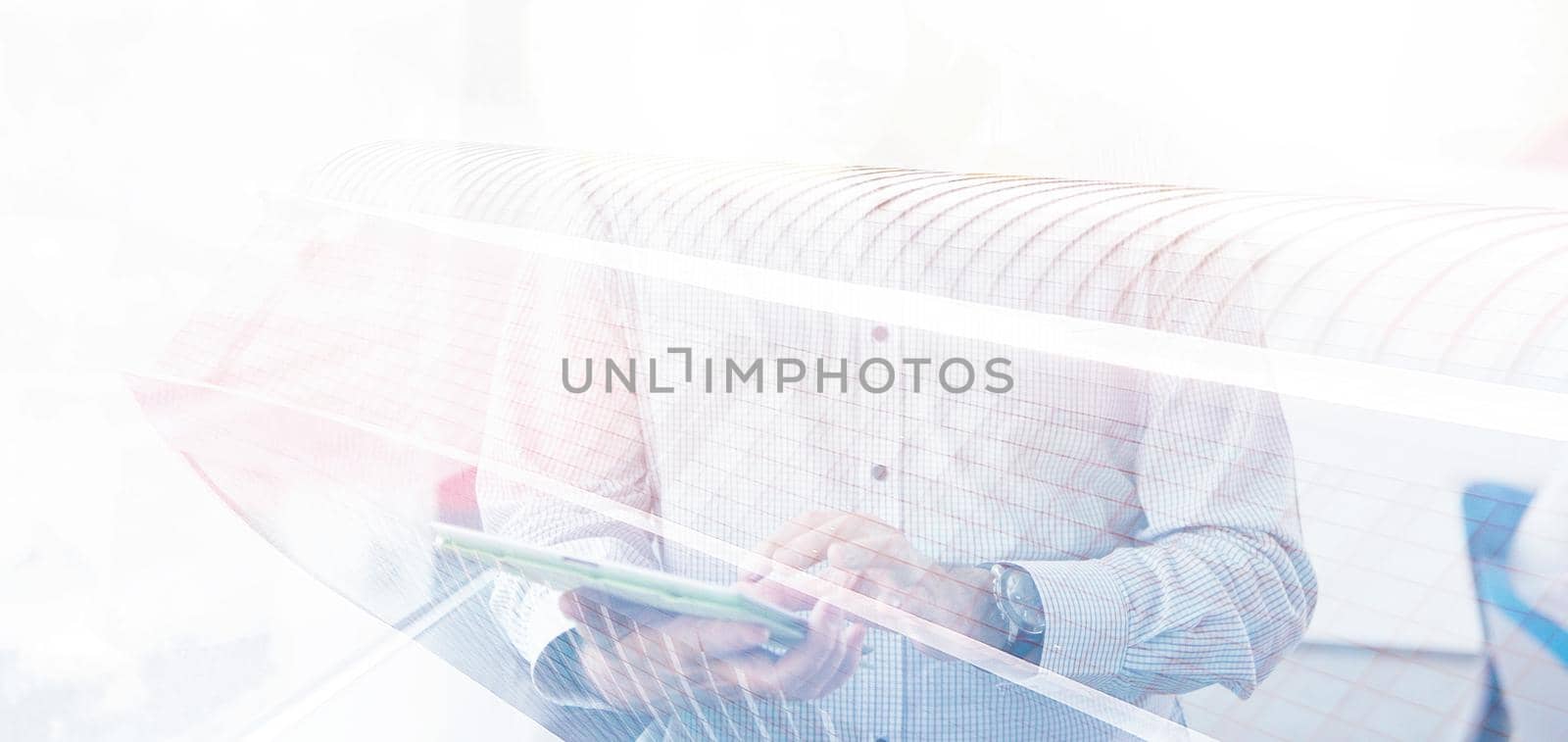 Businessman Using Tablet In Office Building by window by dotshock