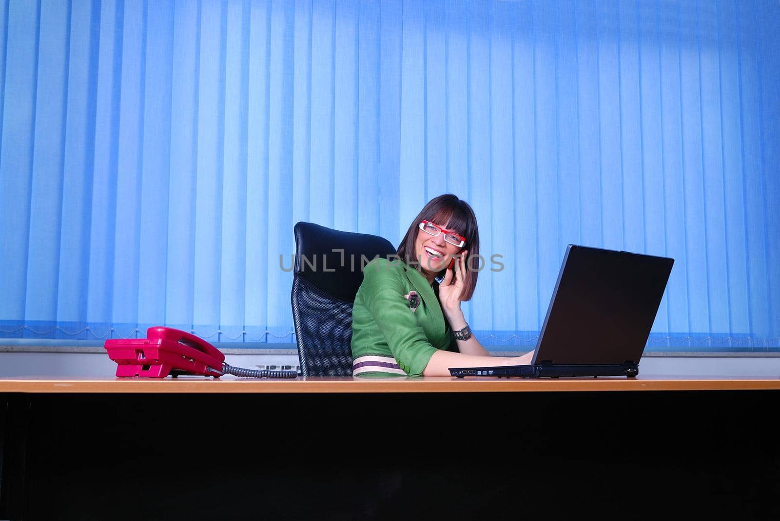 .young businesswoman working on a laptop computer in the office. by dotshock