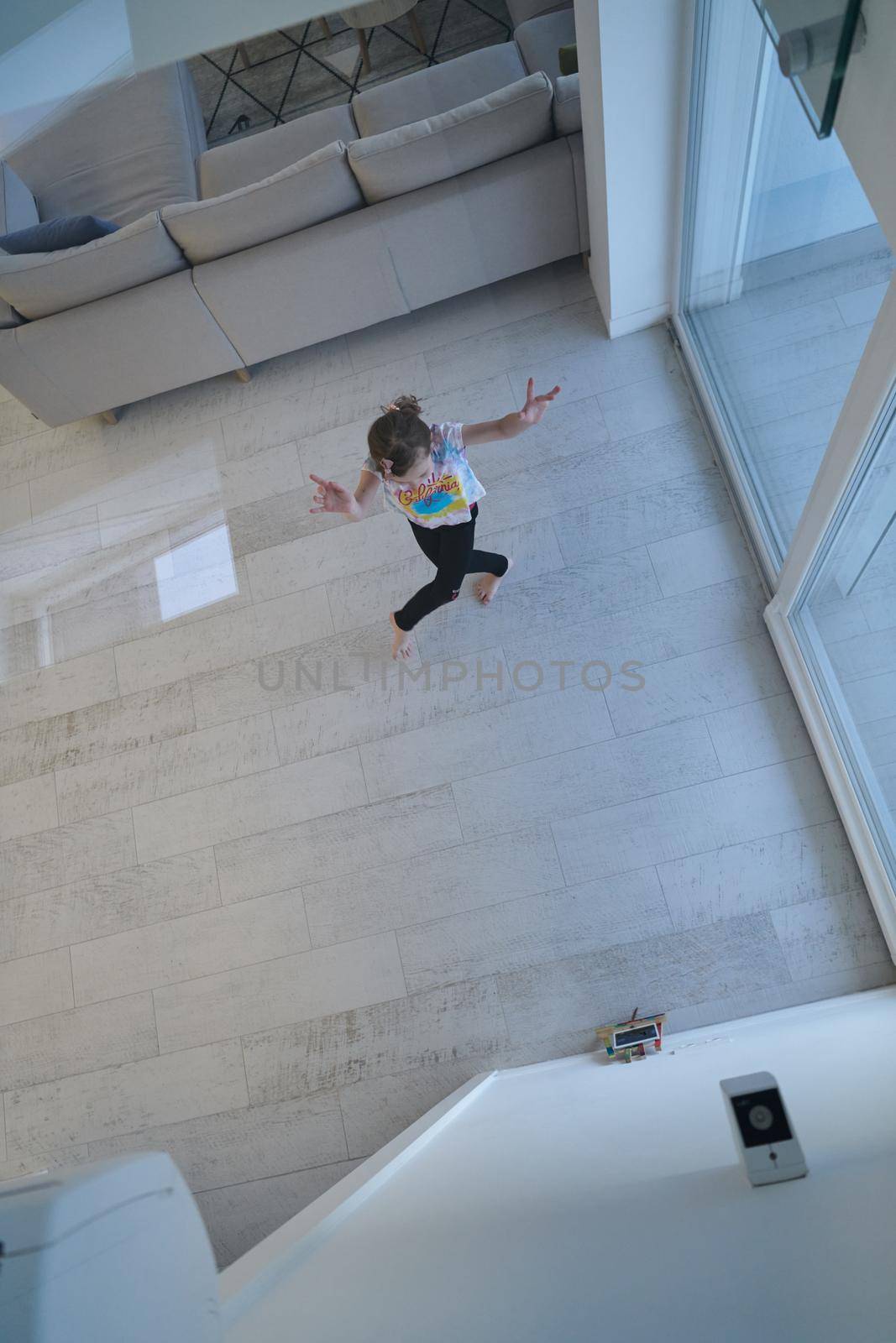 Little girl have online training over  tablet and doing modern ballet dance exercise at home. Online education concept class in modern ballet school. Social distance during quarantine, isolation in coronavirus top view