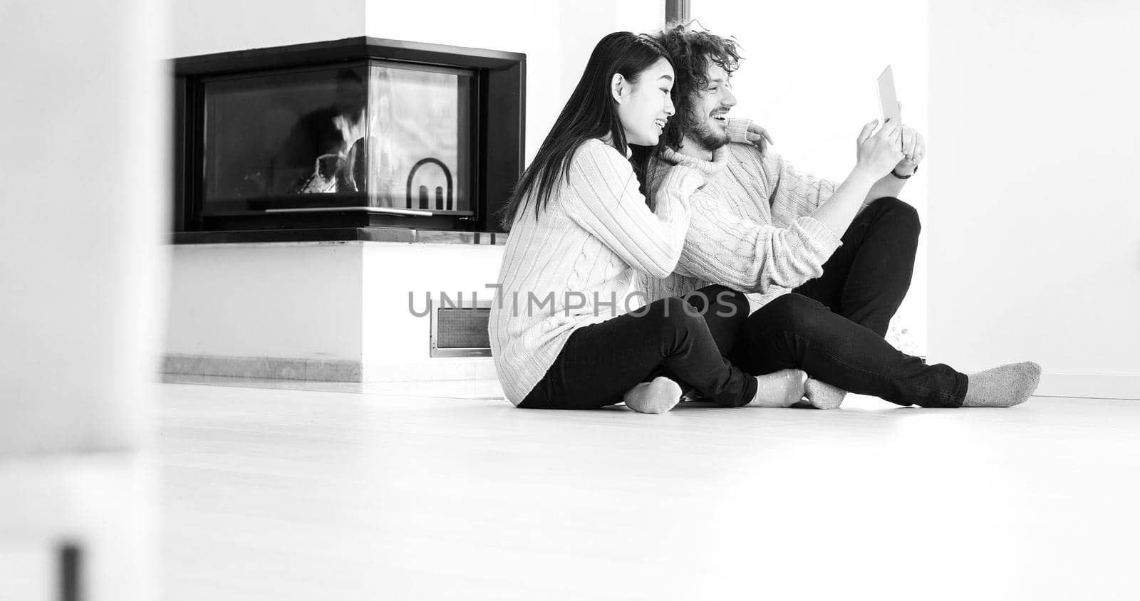Young Couple using digital tablet on the floor by dotshock
