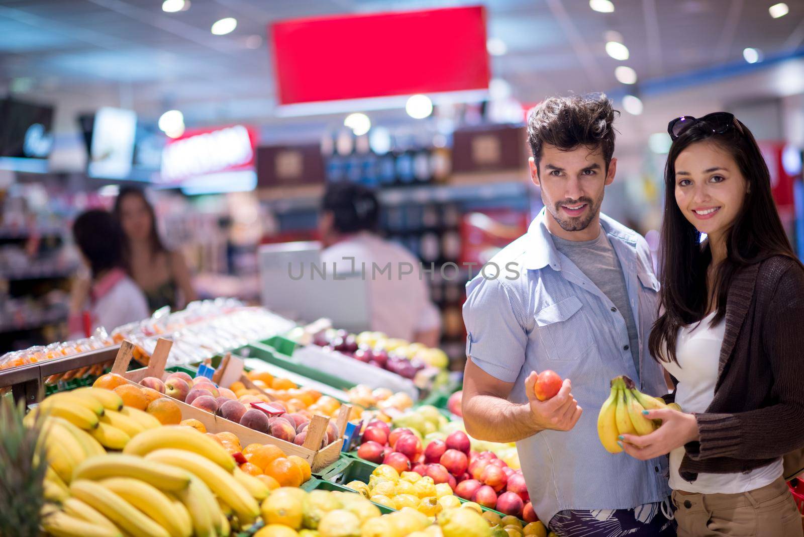 couple shopping in a supermarket by dotshock