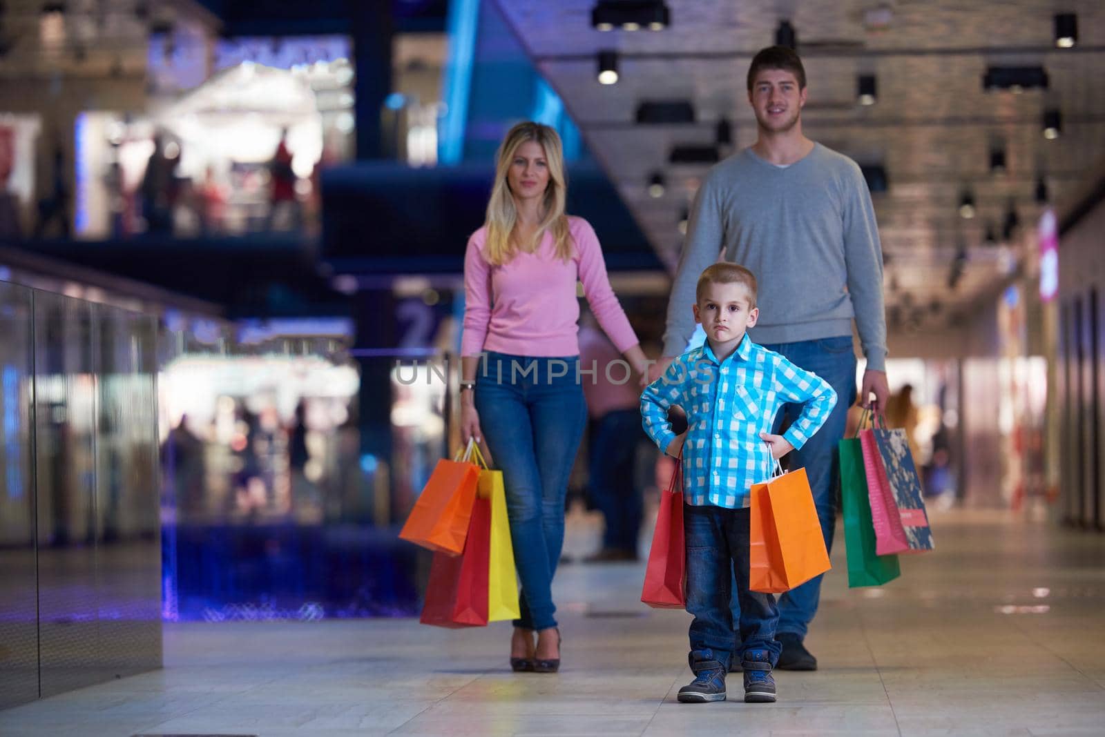 happy  young family with shopping bags in mall