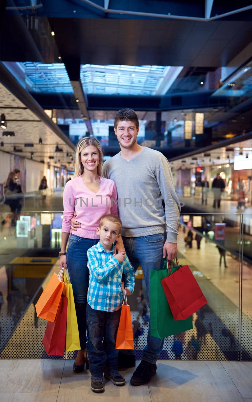young family with shopping bags by dotshock