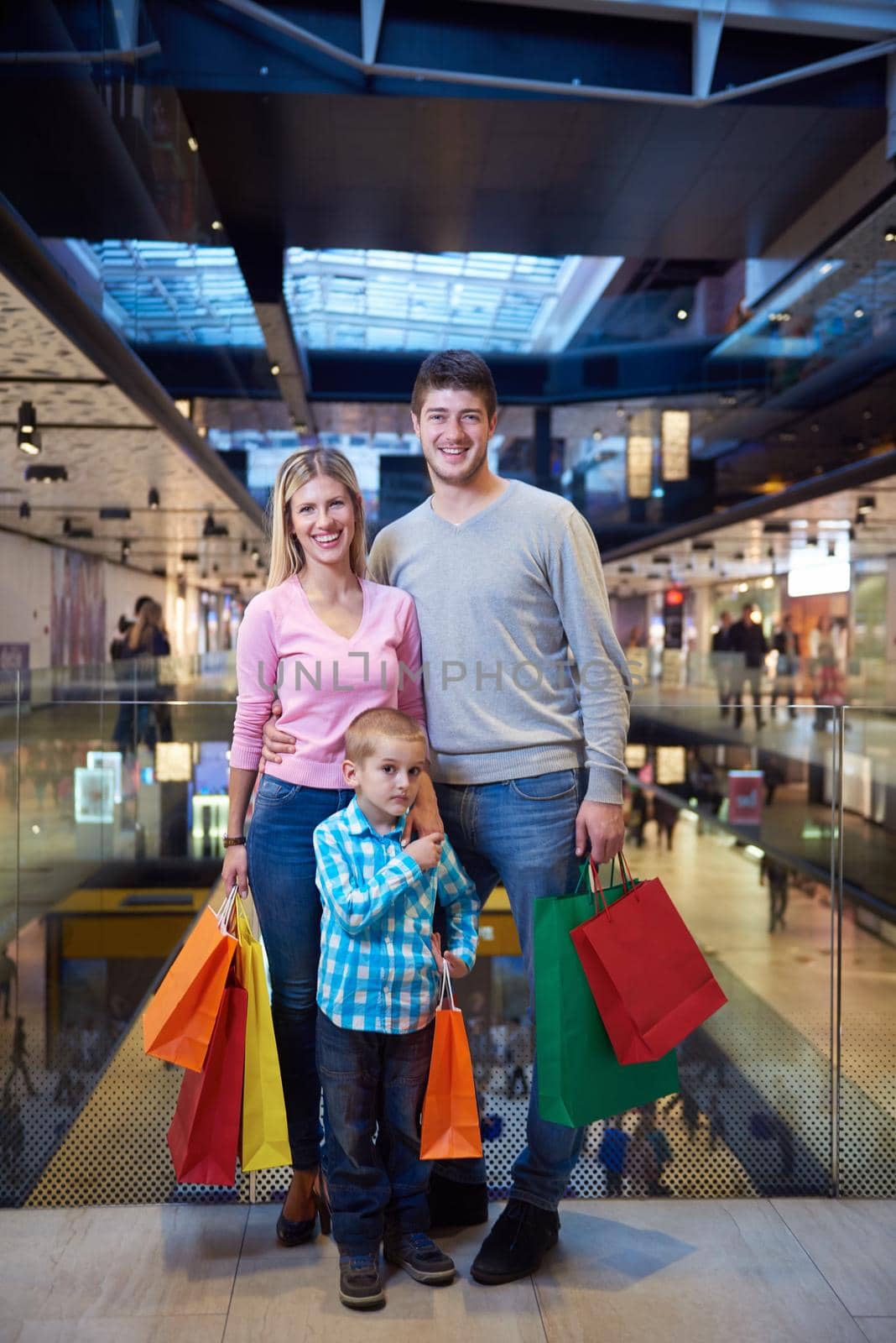 young family with shopping bags by dotshock