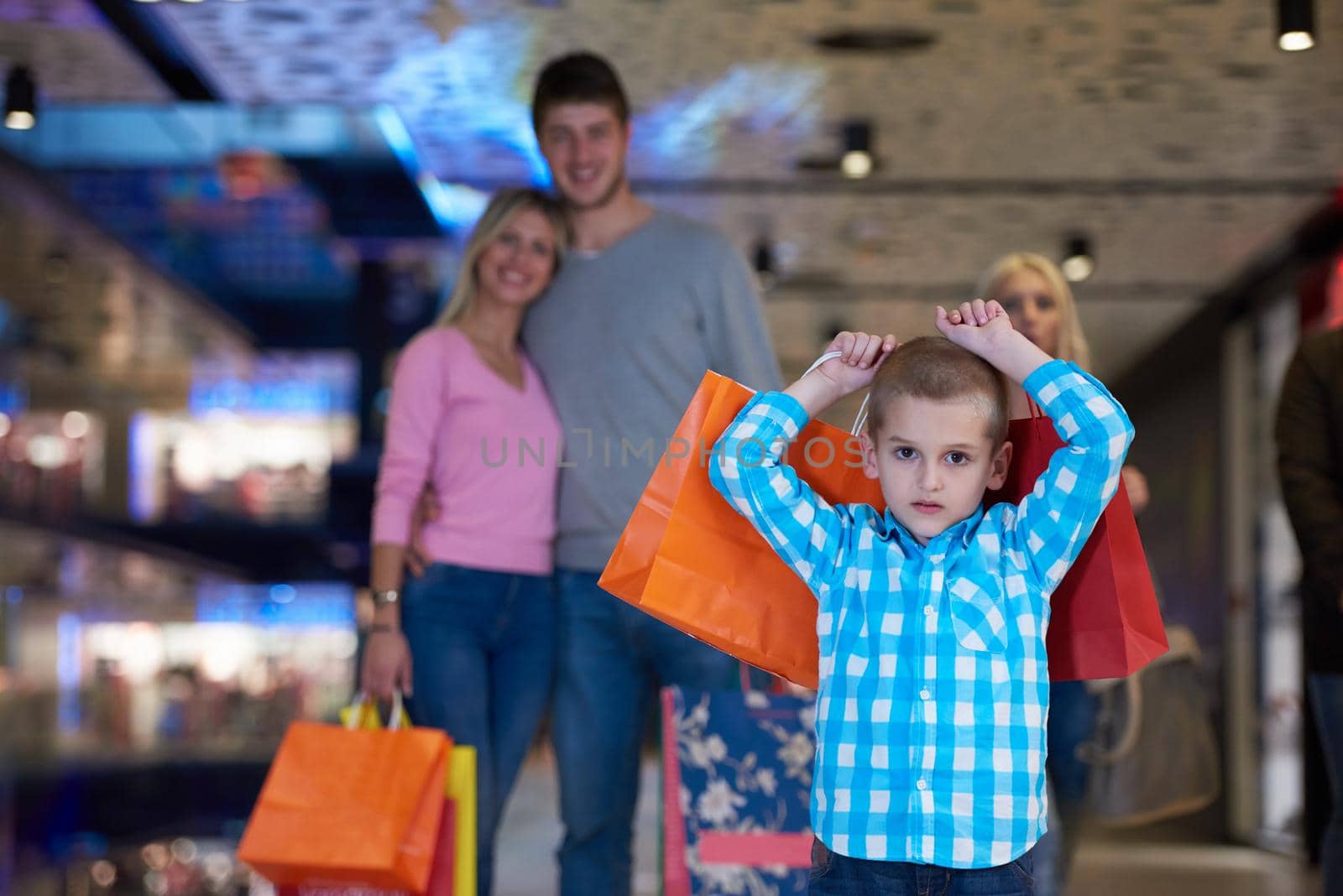 happy  young family with shopping bags in mall