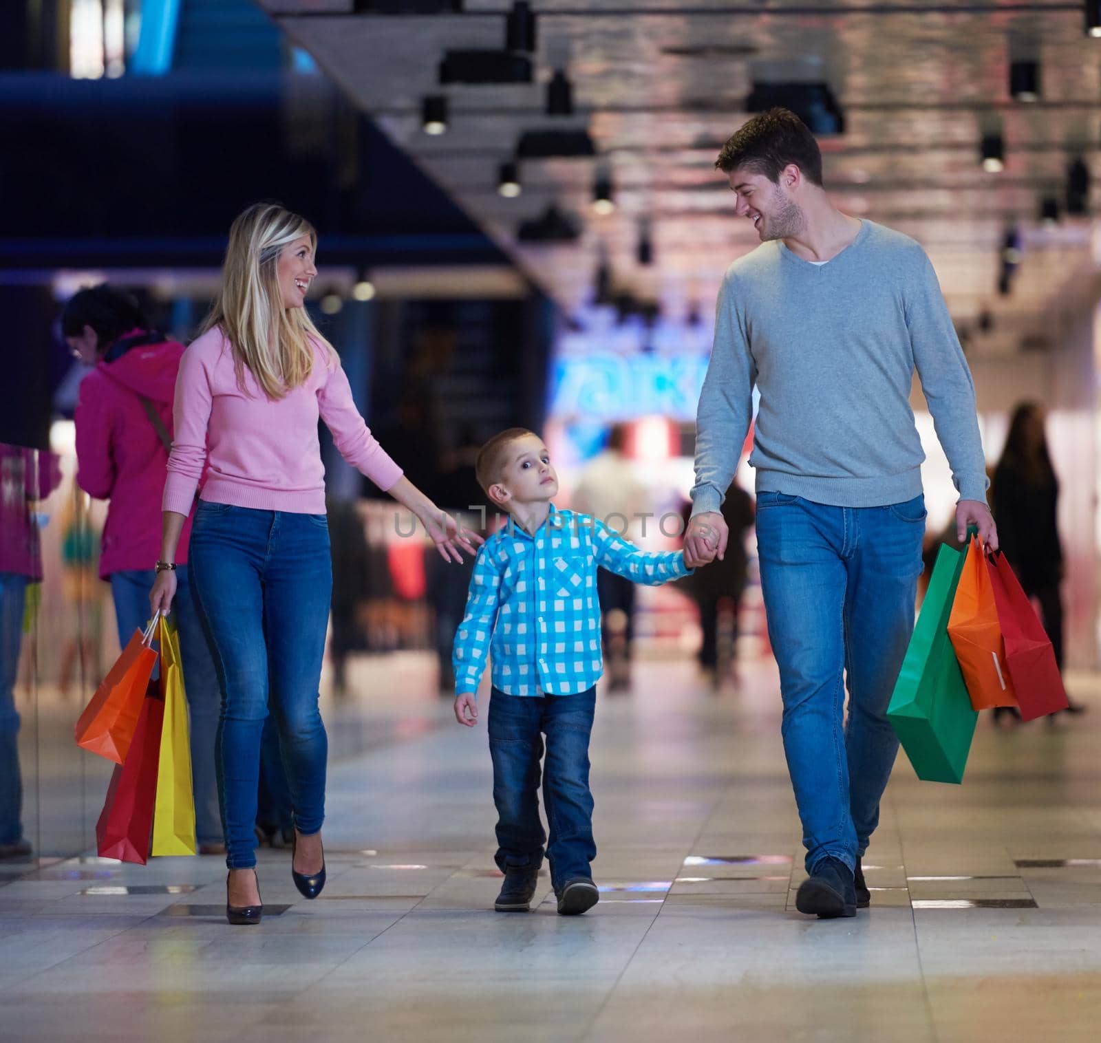 happy  young family with shopping bags in mall