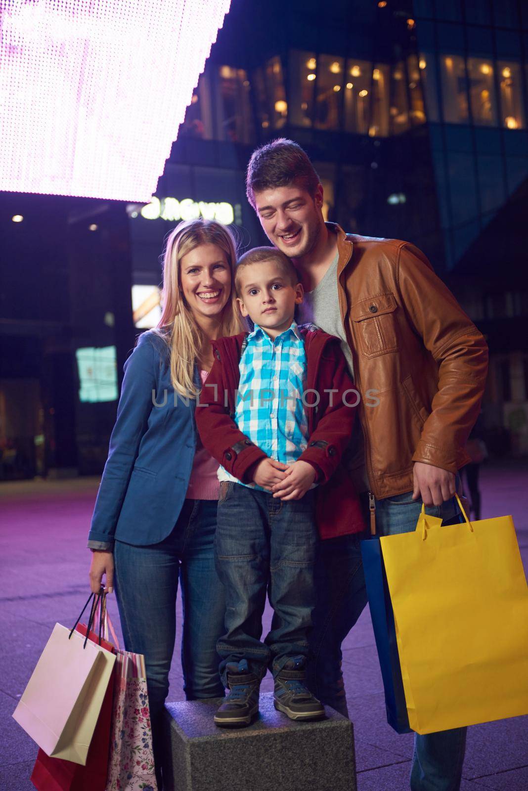 Group Of Friends Enjoying Shopping Trip Together
group of happy young frineds enjoying shopping night and walking on steet on night in with mall in background