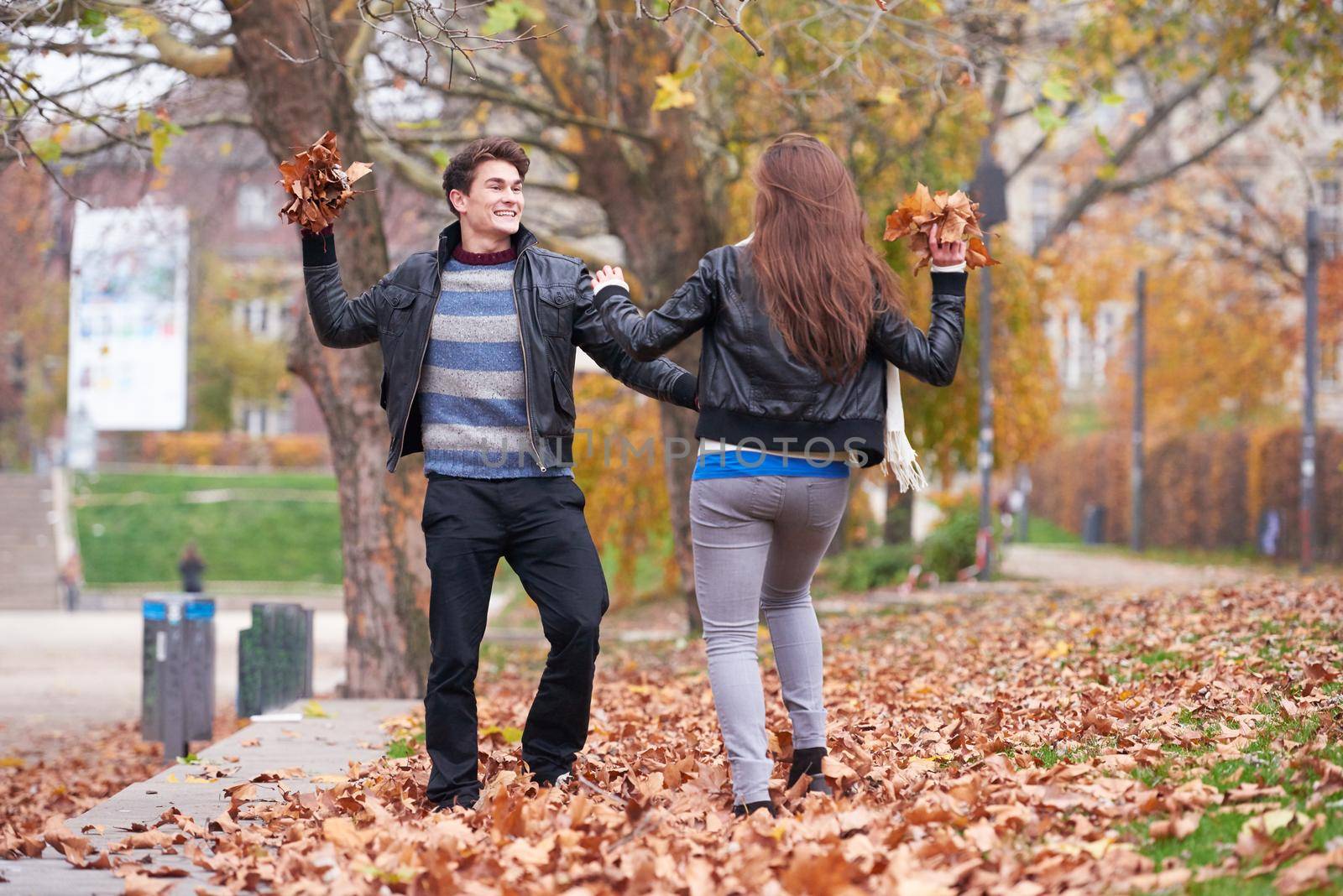 romantic young couple have fun in city park at autumn season