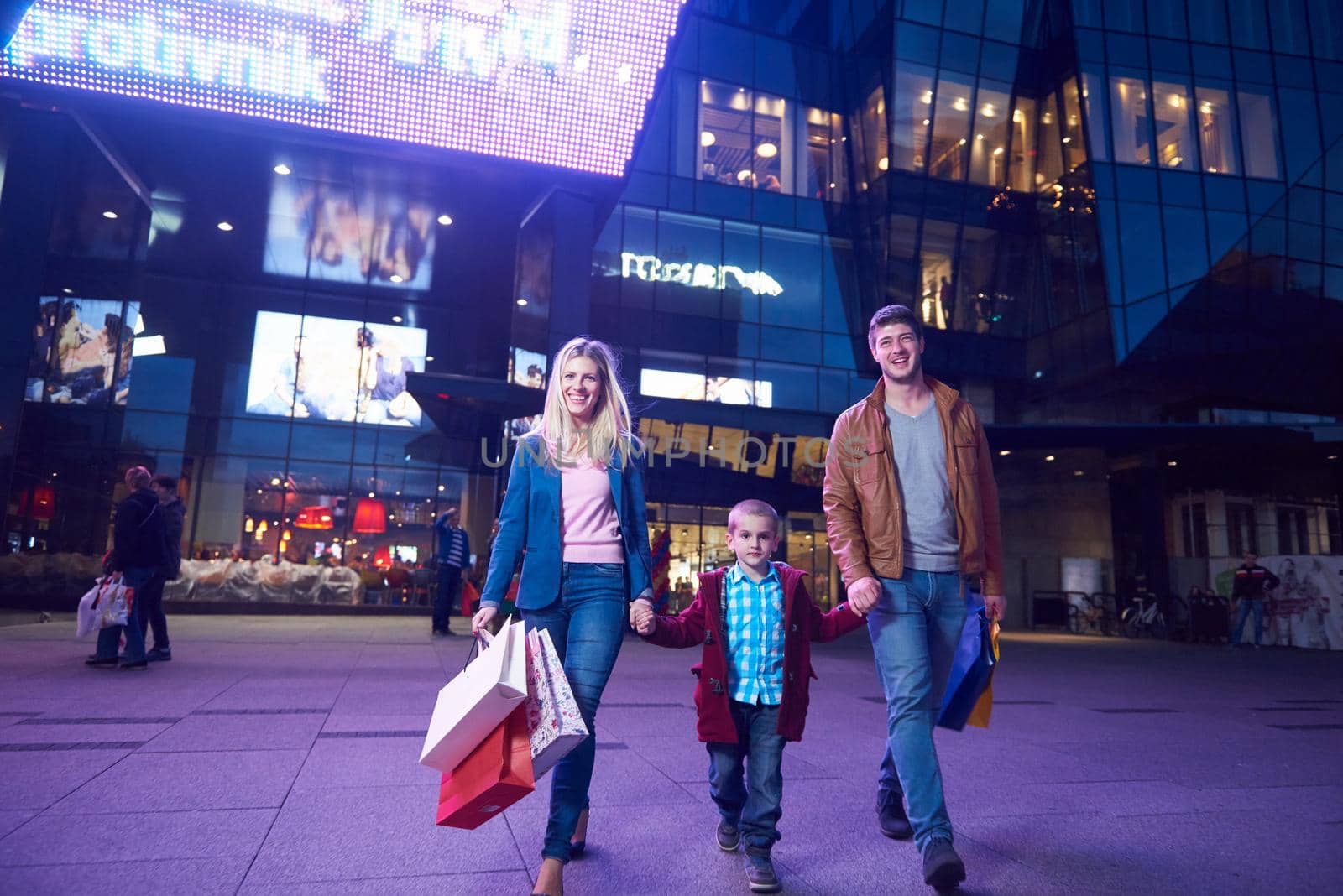 Group Of Friends Enjoying Shopping Trip Together
group of happy young frineds enjoying shopping night and walking on steet on night in with mall in background