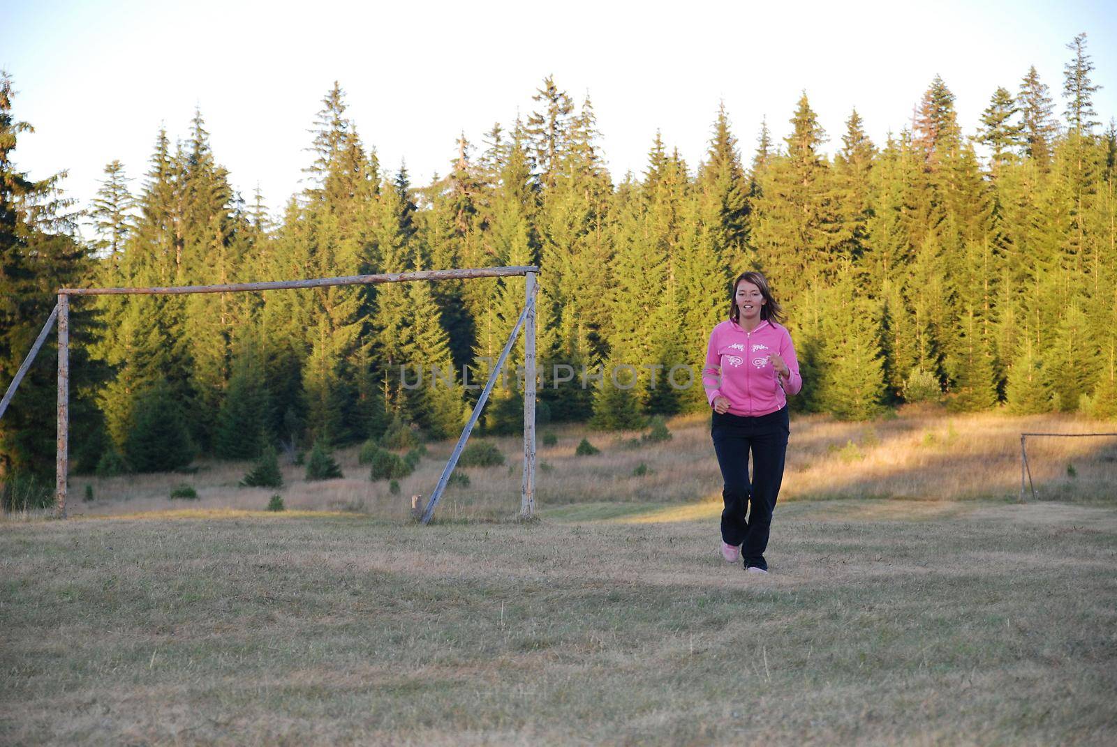 young woman working out in nature