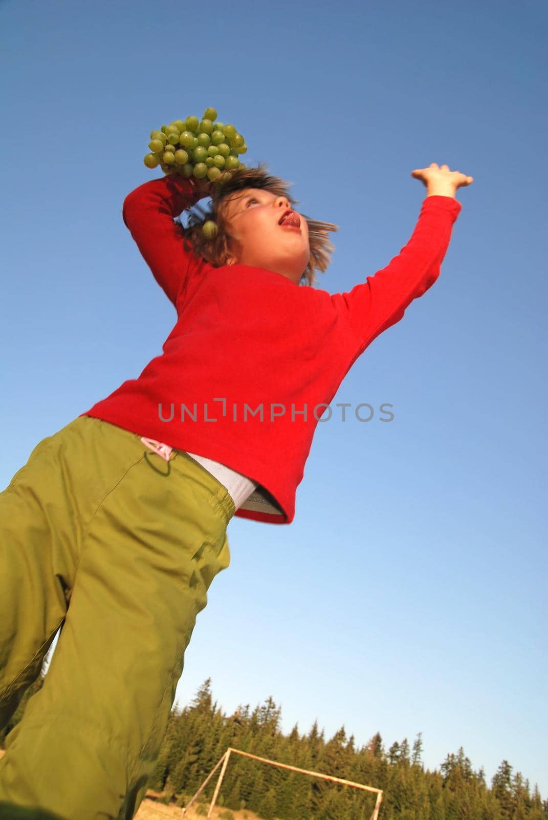 girl with grape outdoor