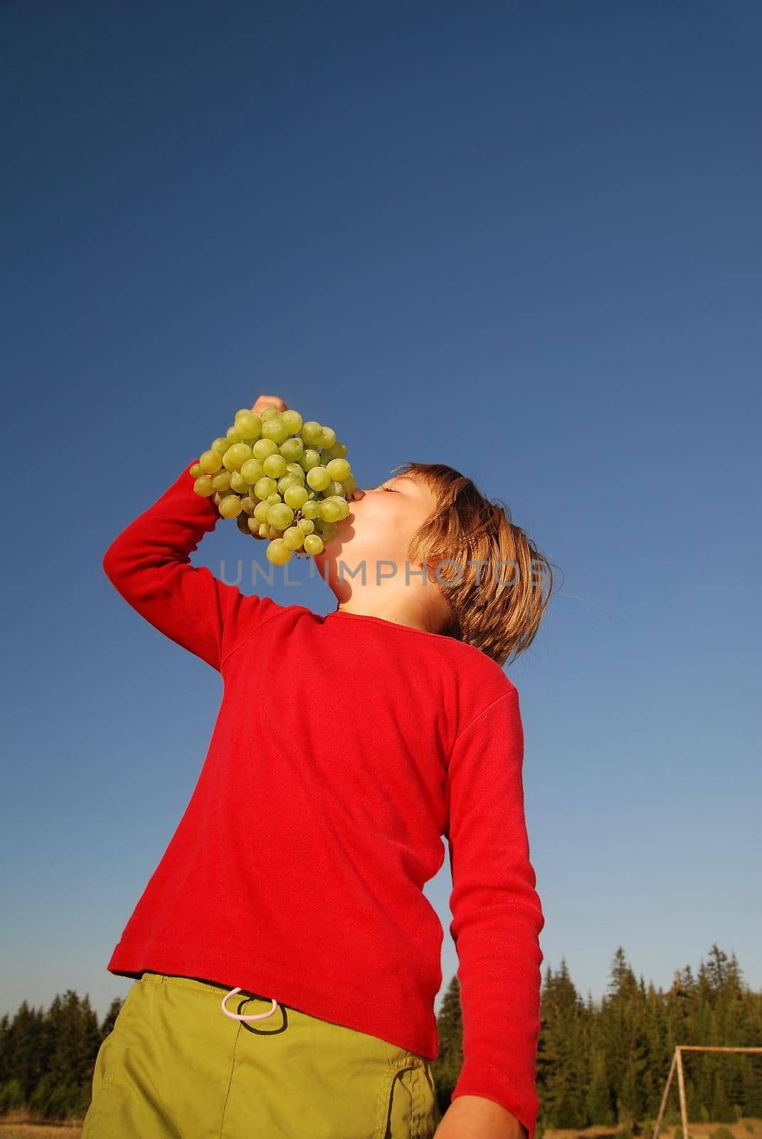 happy girl with grape outside