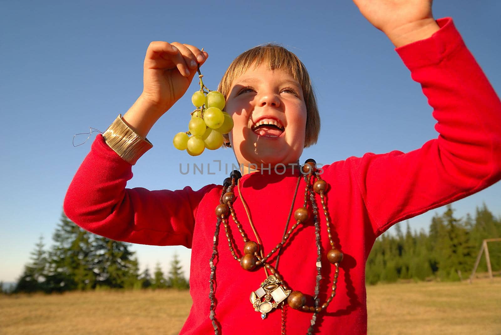 happy girl with grape outside