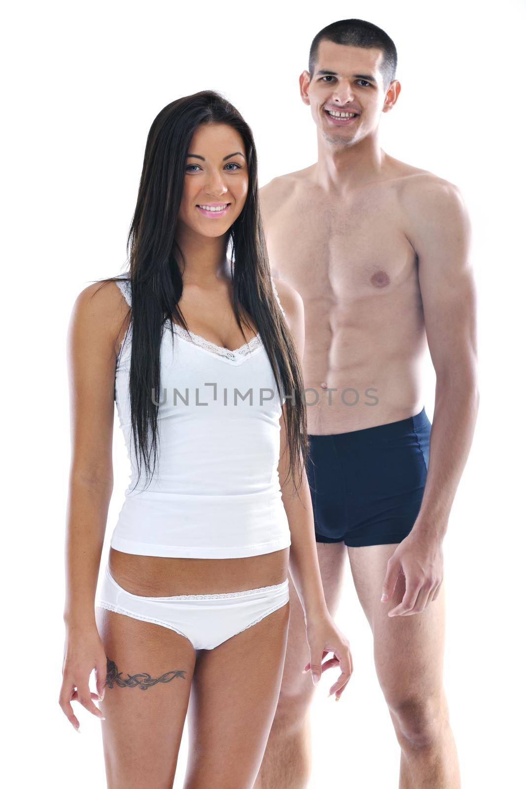 young couple isolated on white in fashionable underwear and blue jeans clothing