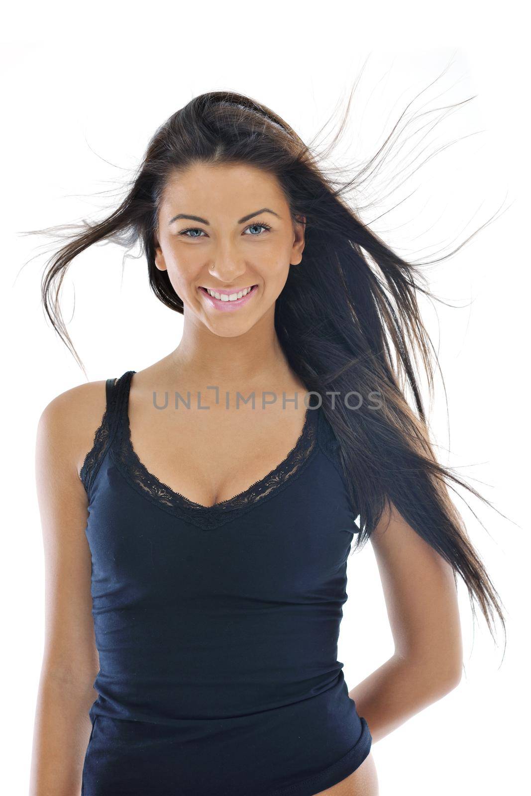 fashion beauty shoot with happy young girl isolated on white with wind in hair  in studio