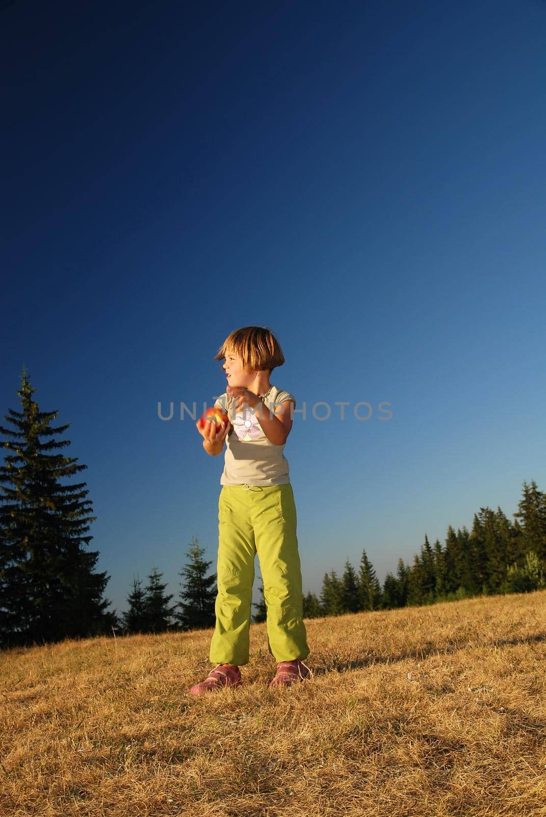 happy girl throwing apple outside by dotshock