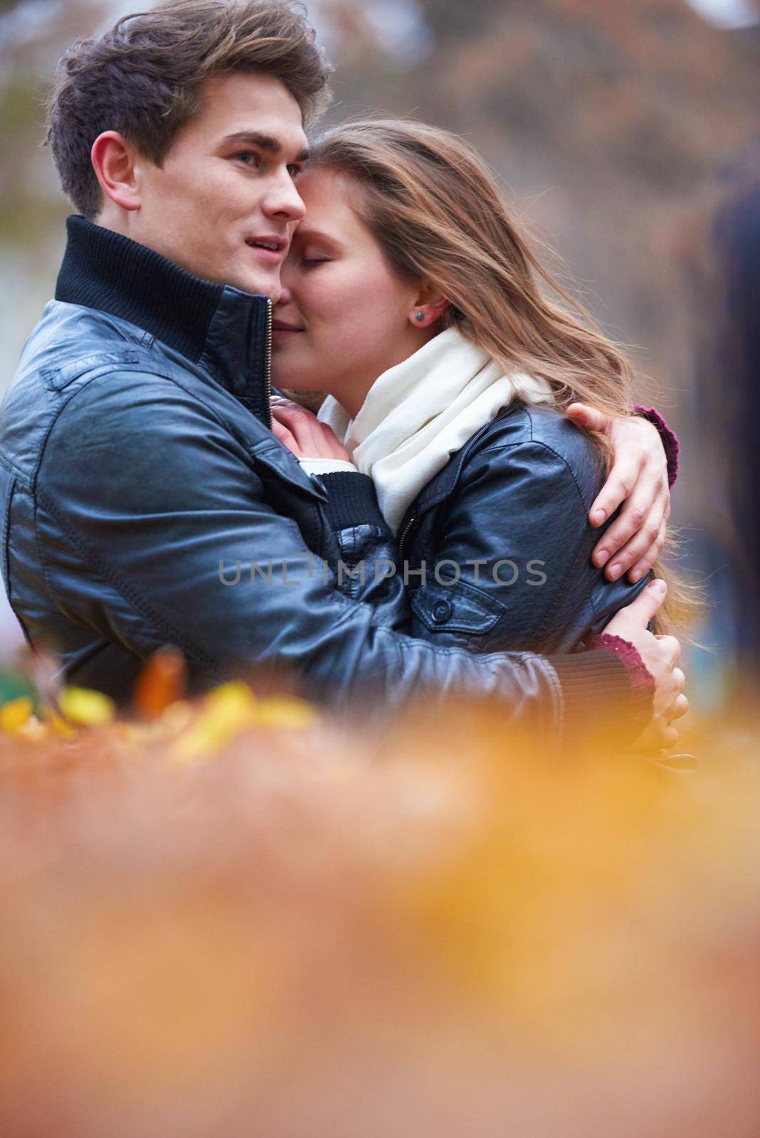 romantic young couple have fun in city park at autumn season