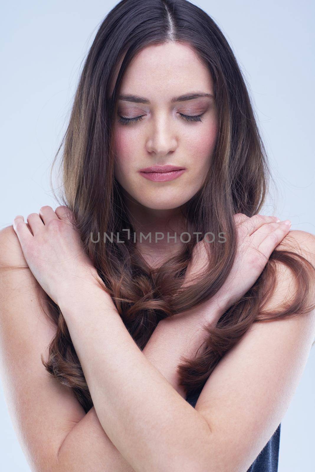 portrait of young nude brunette woman isolated in studio