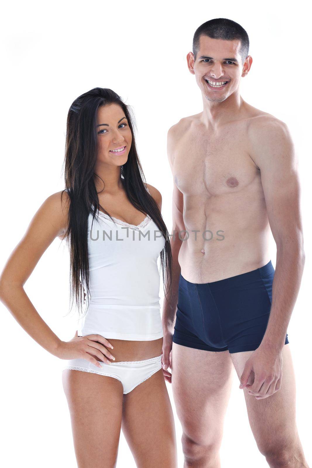 young couple isolated on white in fashionable underwear and blue jeans clothing