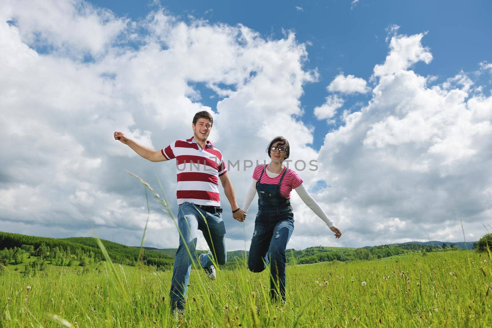 Portrait of romantic young couple in love  smiling together outdoor in nature with blue sky in background