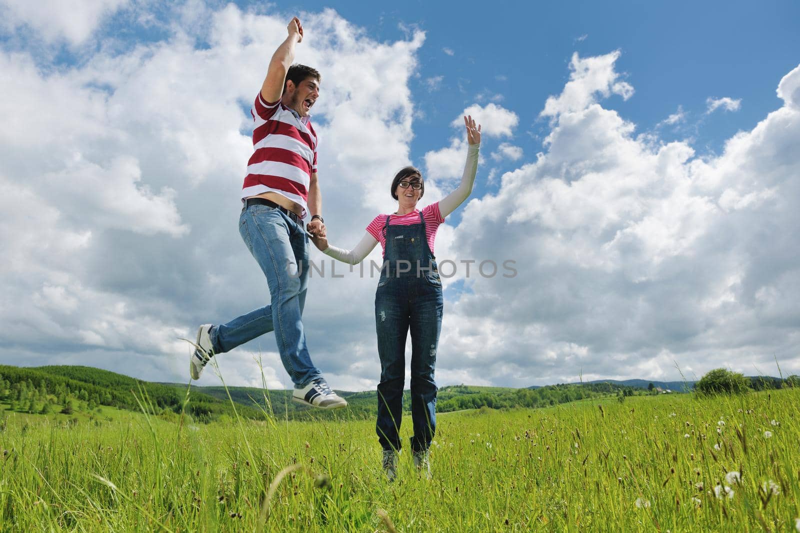 Portrait of romantic young couple in love  smiling together outdoor in nature with blue sky in background