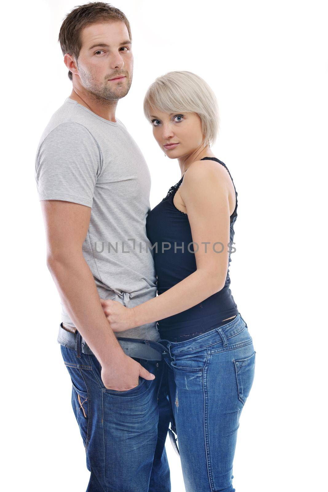 young couple isolated on white in fashionable underwear and blue jeans clothing