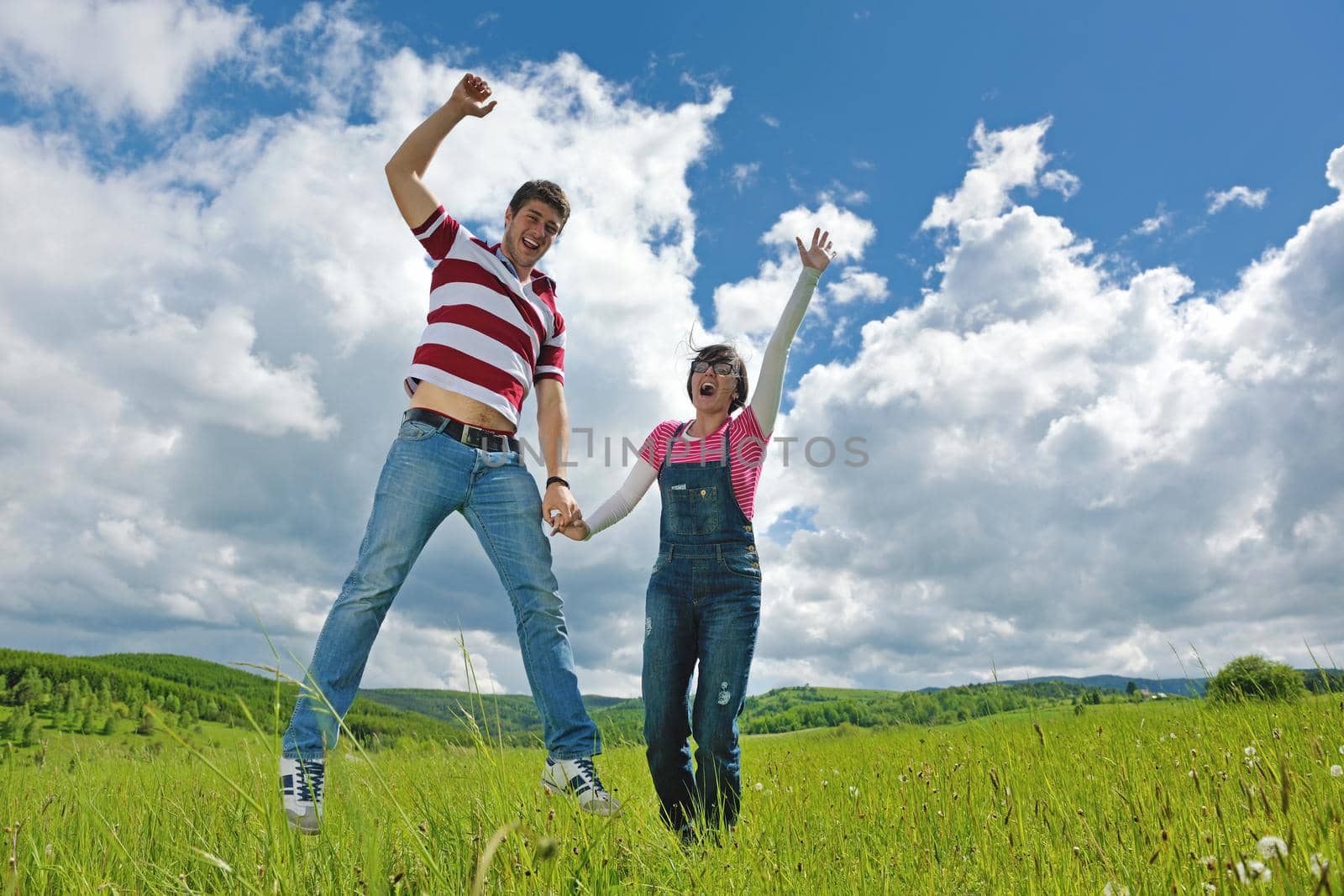 Portrait of romantic young couple in love  smiling together outdoor in nature with blue sky in background